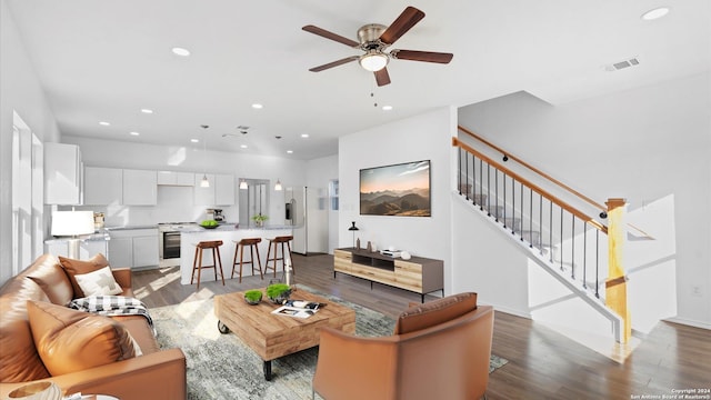 living room featuring dark hardwood / wood-style floors and ceiling fan