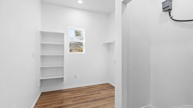 spacious closet featuring hardwood / wood-style floors