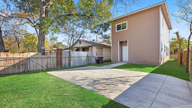 rear view of property with a lawn and a patio area