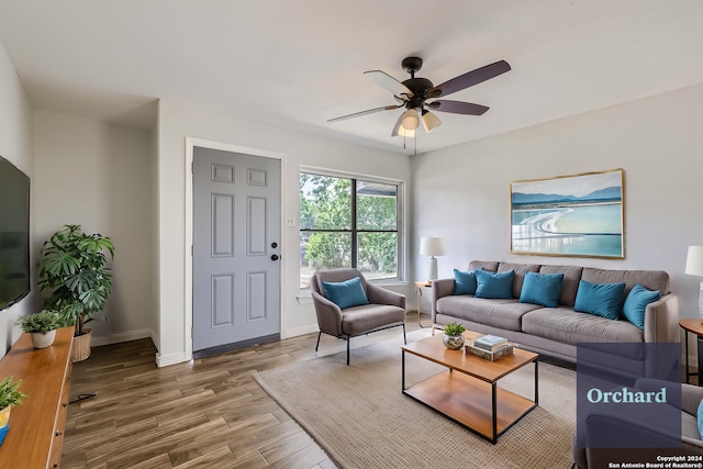 living room with hardwood / wood-style flooring and ceiling fan