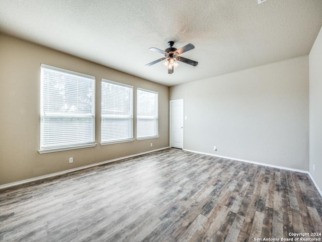 empty room with wood-type flooring, a textured ceiling, and ceiling fan