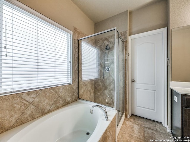 bathroom featuring vanity, a healthy amount of sunlight, and independent shower and bath