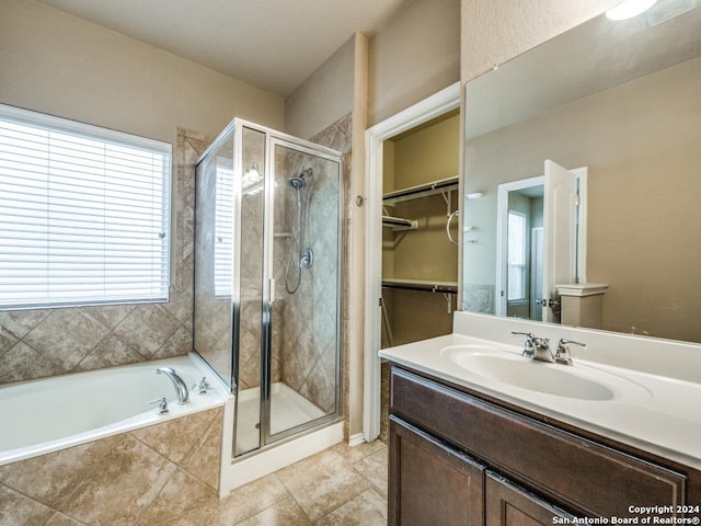 bathroom with vanity and independent shower and bath