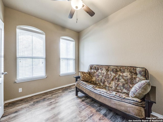 living area featuring hardwood / wood-style flooring and ceiling fan