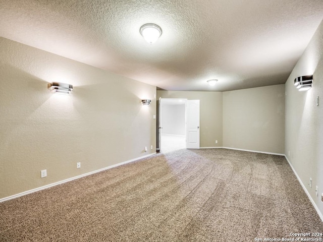 empty room featuring carpet floors and a textured ceiling