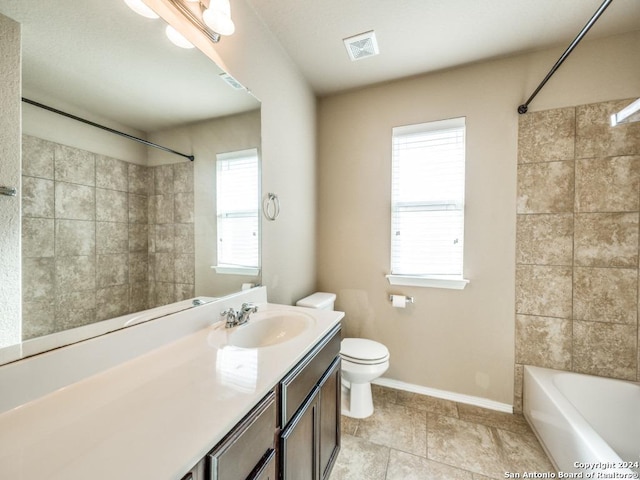 full bathroom with a wealth of natural light, shower / washtub combination, vanity, and toilet