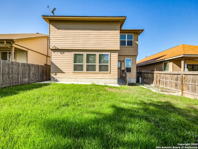 rear view of house with a lawn