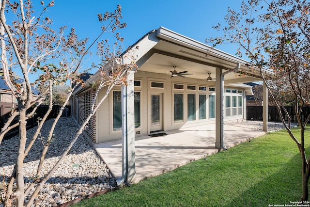 back of house with a lawn, ceiling fan, and a patio