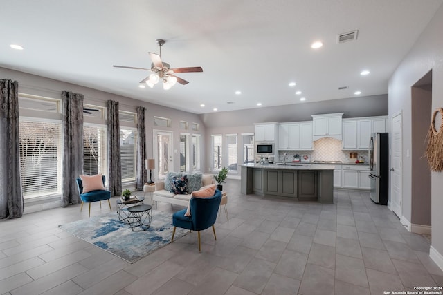 living room featuring ceiling fan and sink