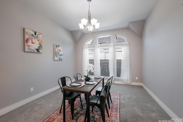 carpeted dining room featuring a notable chandelier and vaulted ceiling