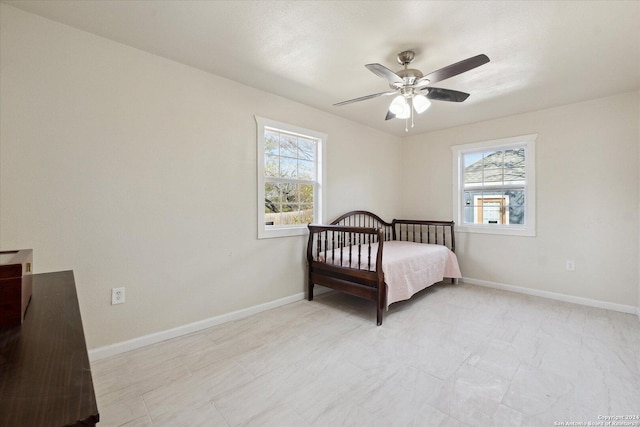 bedroom featuring ceiling fan and multiple windows