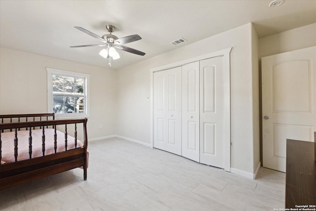 bedroom with ceiling fan and a closet