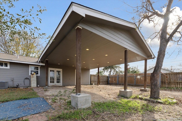 back of property featuring central AC and french doors