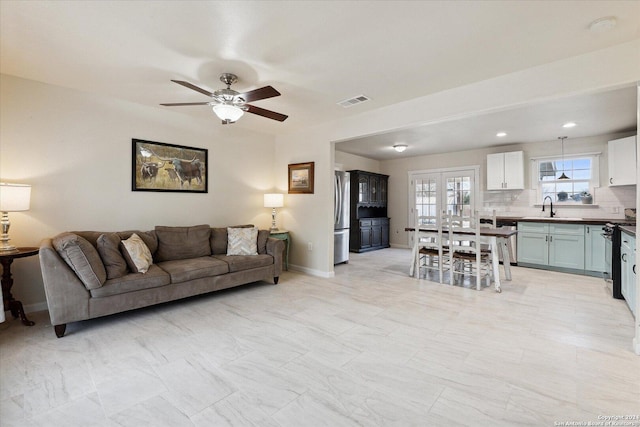 living room with ceiling fan and sink