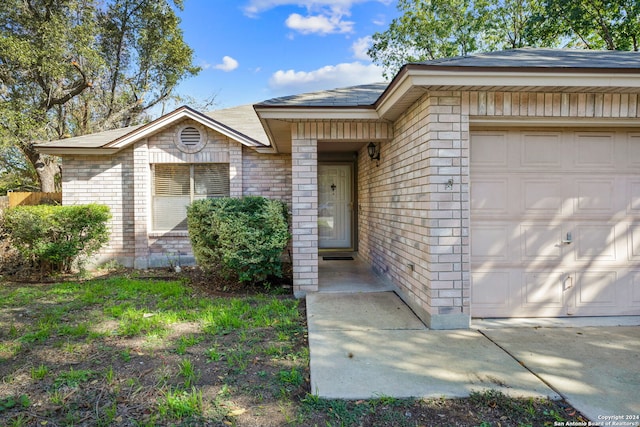 view of exterior entry featuring a garage