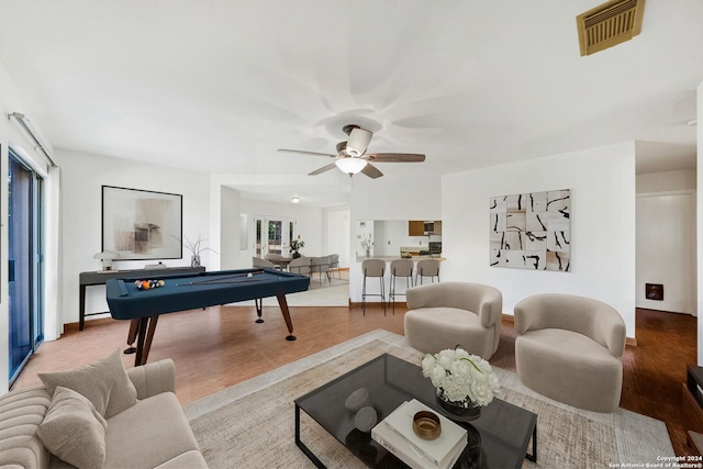 living room with hardwood / wood-style flooring, ceiling fan, and a healthy amount of sunlight