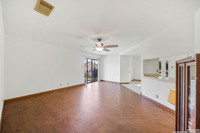 empty room with french doors, light hardwood / wood-style floors, and ceiling fan