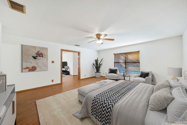 bedroom with ceiling fan and wood-type flooring