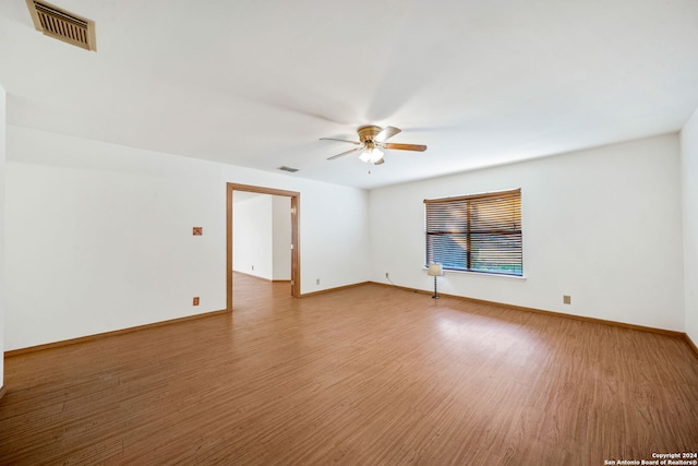 empty room with wood-type flooring and ceiling fan