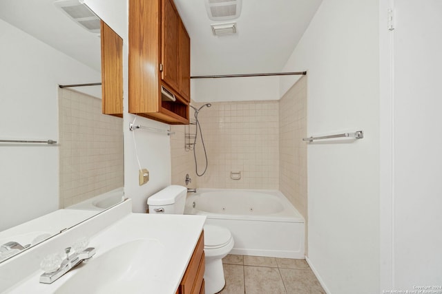 full bathroom with tile patterned flooring, vanity, tiled shower / bath combo, and toilet