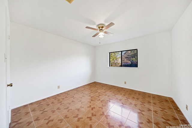 spare room with tile patterned floors and ceiling fan