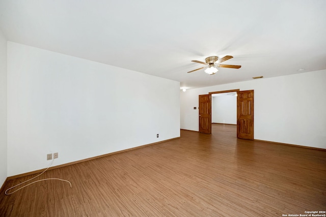 empty room featuring ceiling fan and hardwood / wood-style flooring