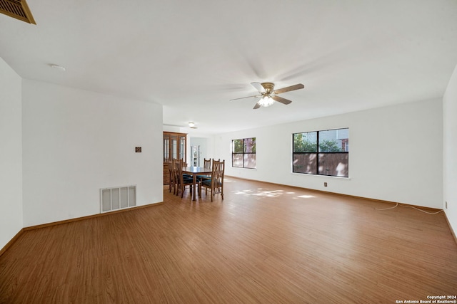 unfurnished room with ceiling fan and wood-type flooring