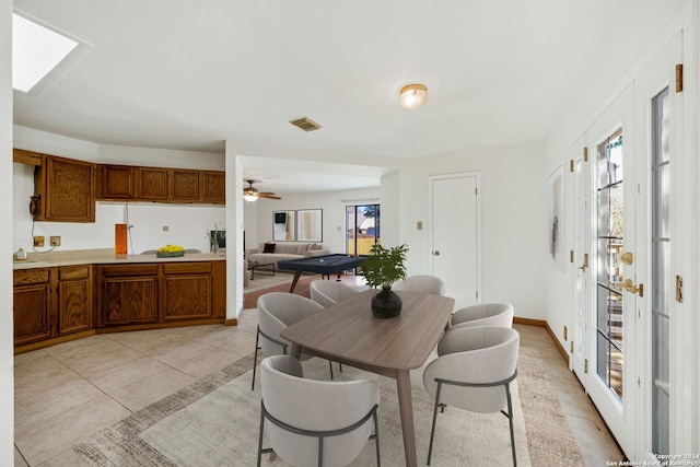 tiled dining area featuring ceiling fan