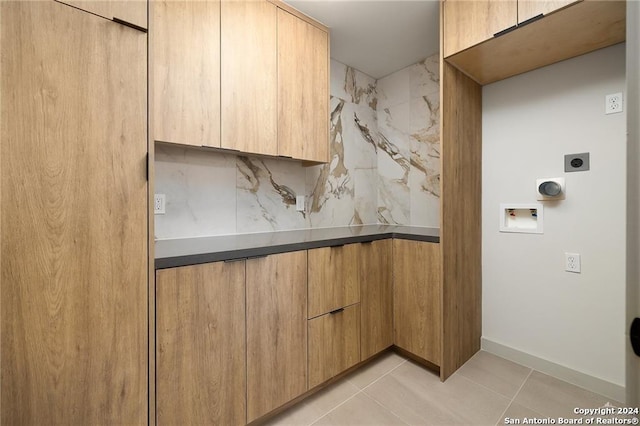 kitchen with light tile patterned flooring, light brown cabinetry, and tasteful backsplash