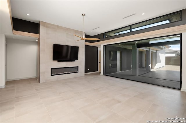 unfurnished living room with a tiled fireplace