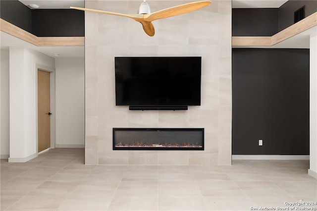 details featuring a tile fireplace and ceiling fan