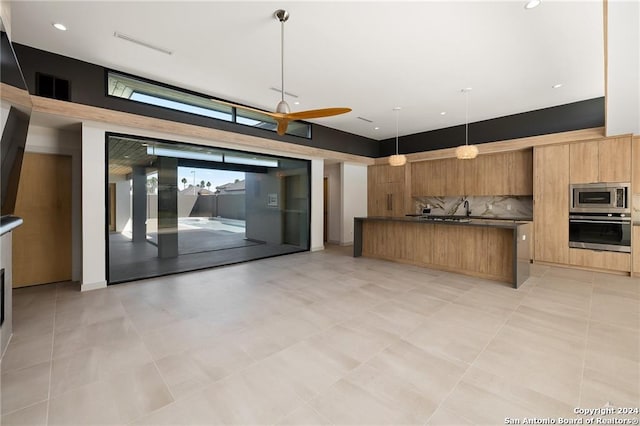 kitchen with tasteful backsplash, pendant lighting, and stainless steel appliances