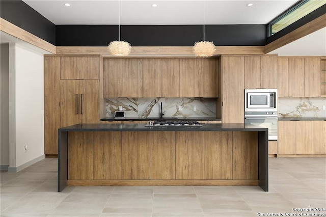 kitchen featuring decorative light fixtures, decorative backsplash, and stainless steel appliances