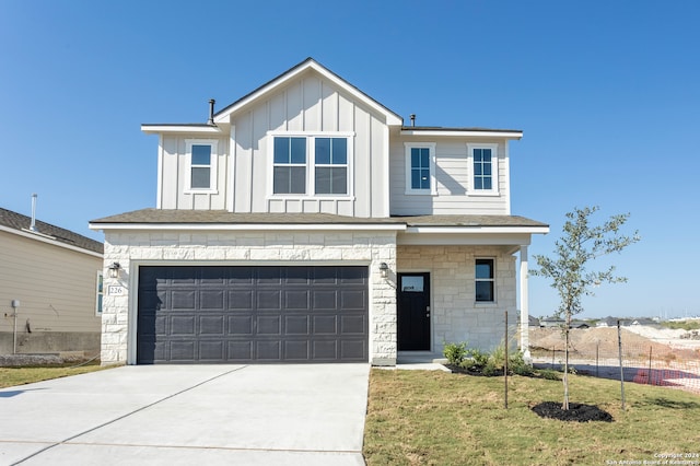 view of front of house with a garage and a front lawn