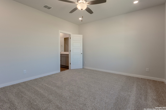 empty room with ceiling fan and carpet floors