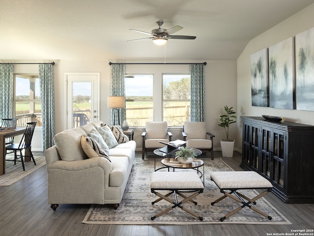 living room with ceiling fan, dark hardwood / wood-style flooring, and lofted ceiling