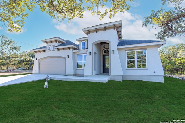 view of front of house with a front yard and a garage