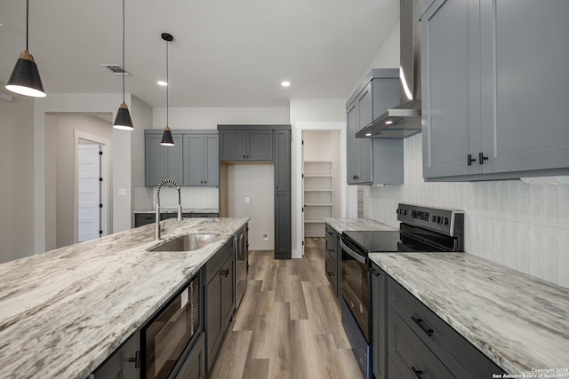 kitchen with built in microwave, tasteful backsplash, light stone counters, black electric range oven, and pendant lighting