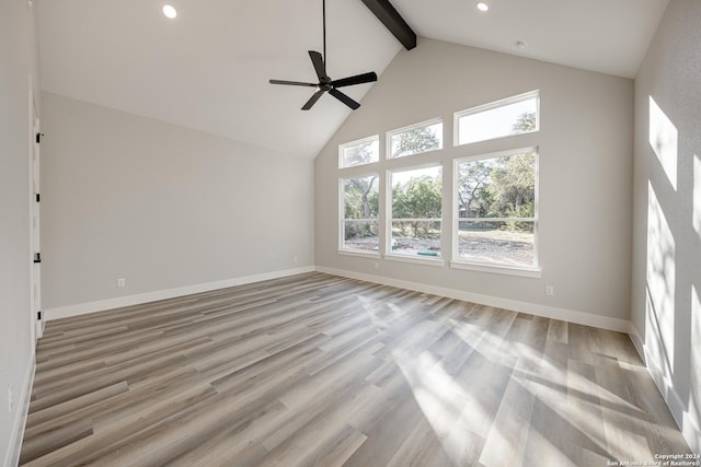 unfurnished living room with beamed ceiling, light hardwood / wood-style floors, and high vaulted ceiling