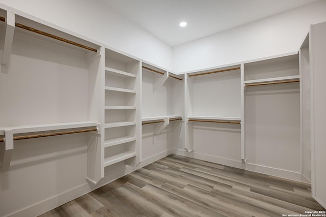 spacious closet with light hardwood / wood-style floors