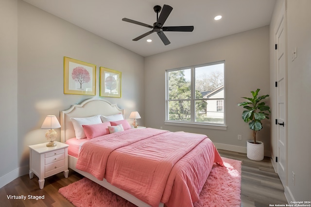 bedroom with ceiling fan and dark hardwood / wood-style flooring