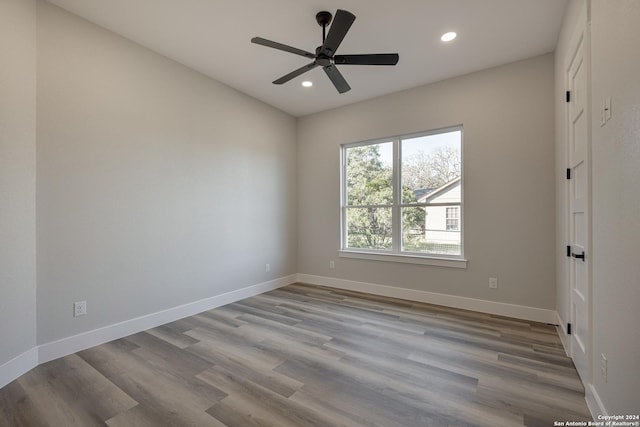 spare room featuring light wood-type flooring and ceiling fan