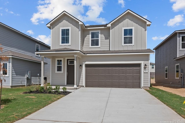 view of front of house with a front yard and a garage