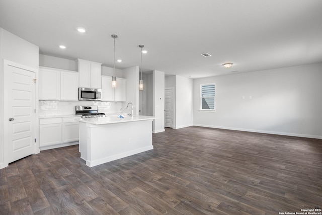 kitchen with white cabinets, decorative light fixtures, stainless steel appliances, and dark hardwood / wood-style floors