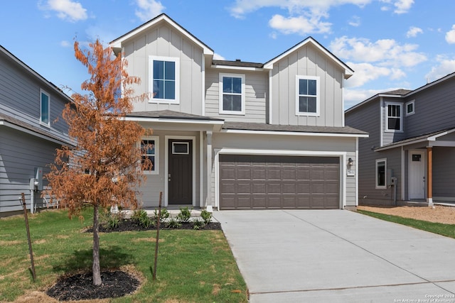 view of front of home with a front lawn and a garage