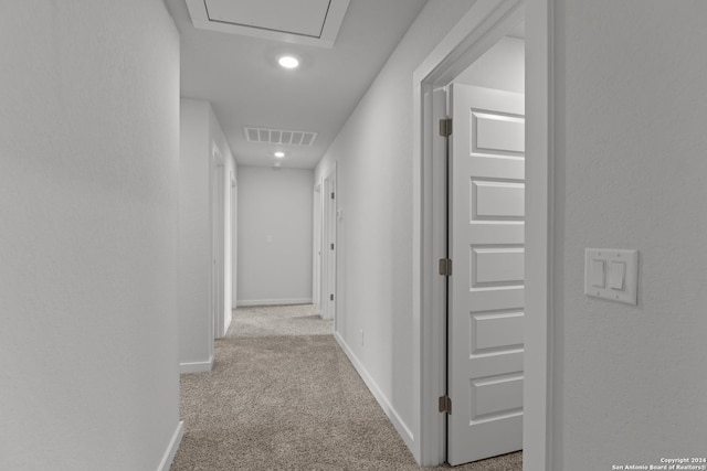 hallway featuring light colored carpet