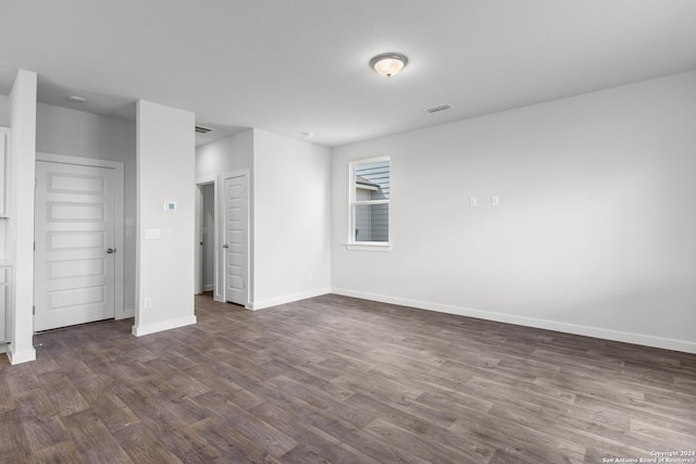 unfurnished bedroom featuring dark hardwood / wood-style flooring