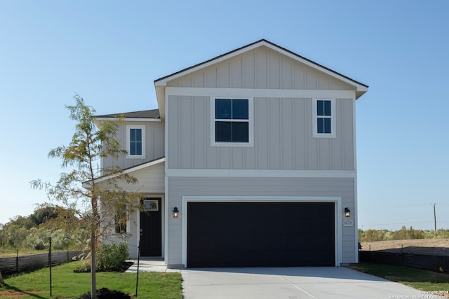 view of front of home with a garage and a front lawn