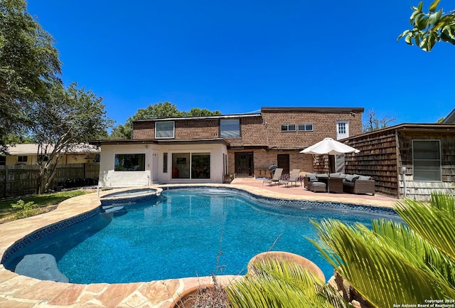 view of pool featuring an in ground hot tub, a patio, and an outdoor living space