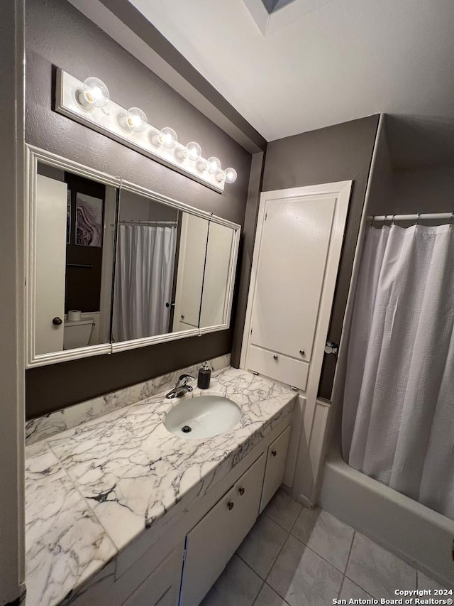 bathroom with tile patterned flooring, vanity, and shower / tub combo with curtain